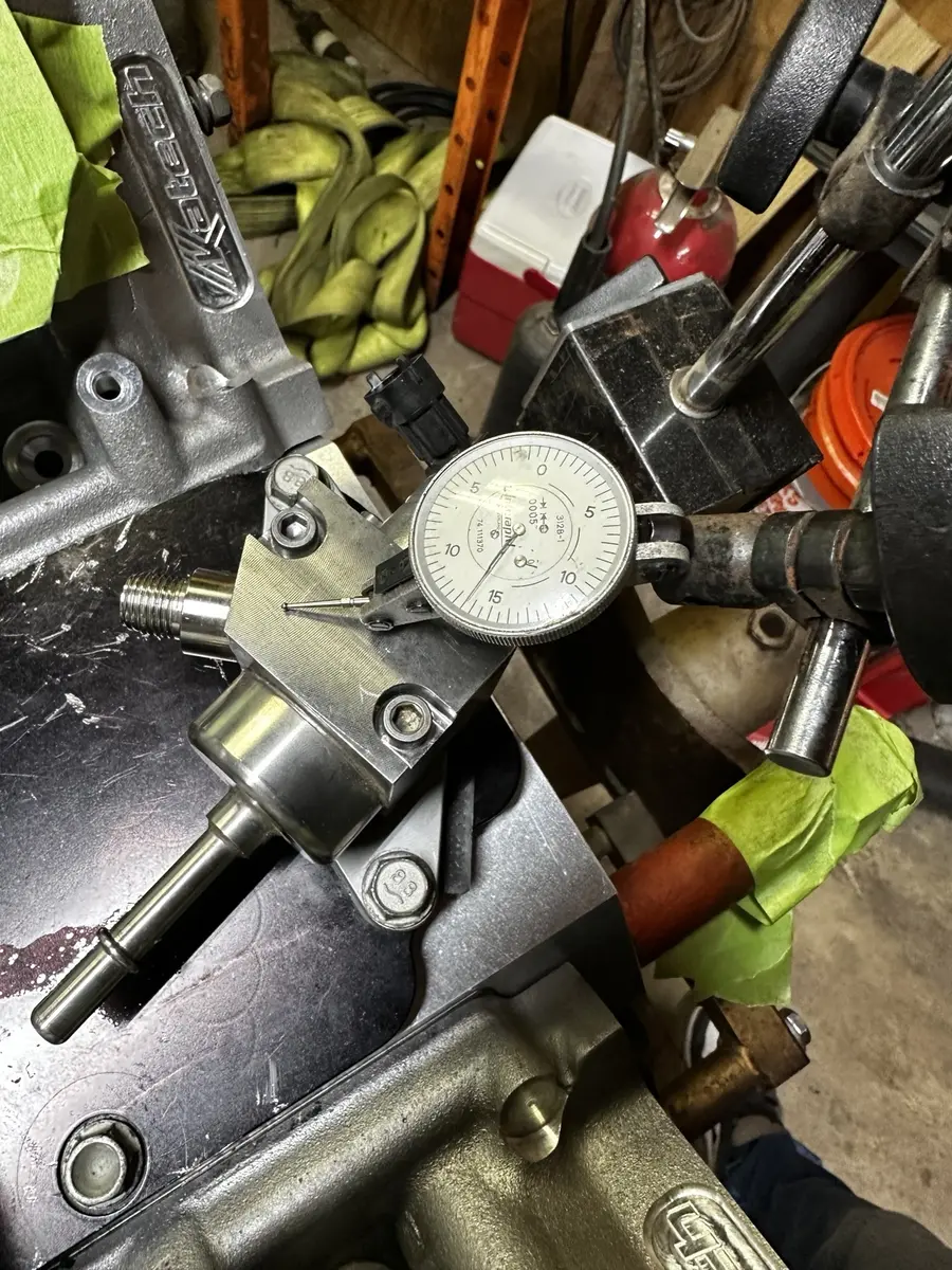Gen V high-pressure fuel pump travel being measured with a dial indicator